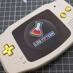 Hand cast custom resin buttons for Nintendo Game Boy Advance - Chrome Gold | Lab Fifteen Co